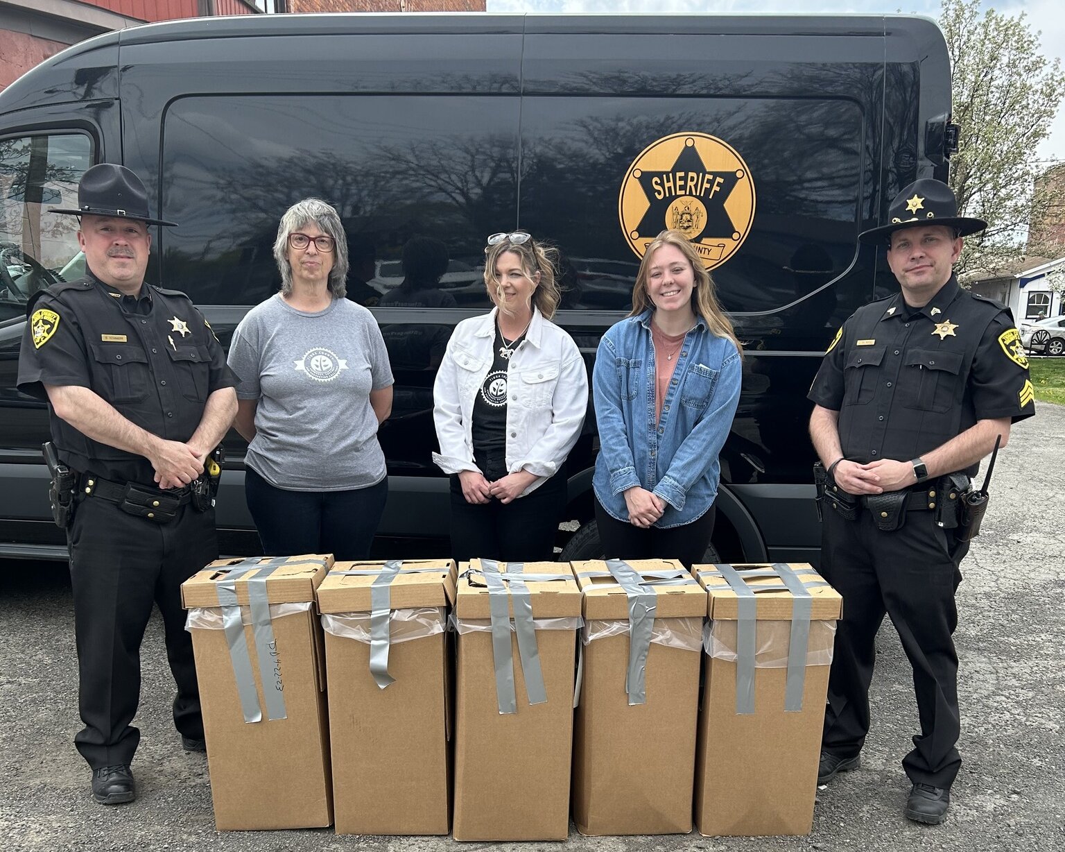 Tioga ASAP members and local police stand with boxes of items received during Drug Take Back Day